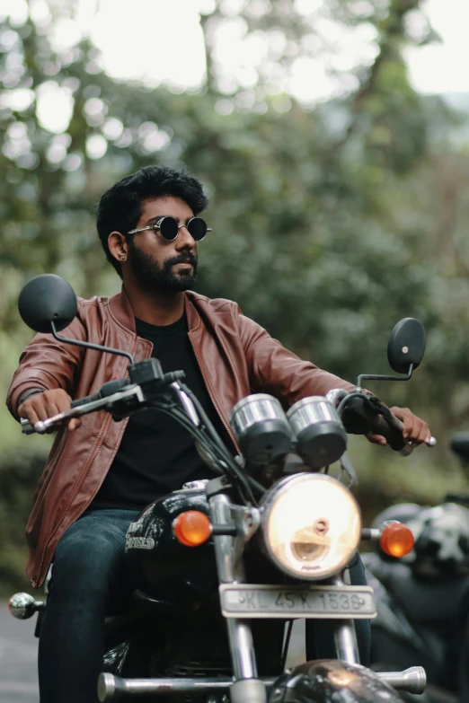 a man sits on the back of his motorcycle