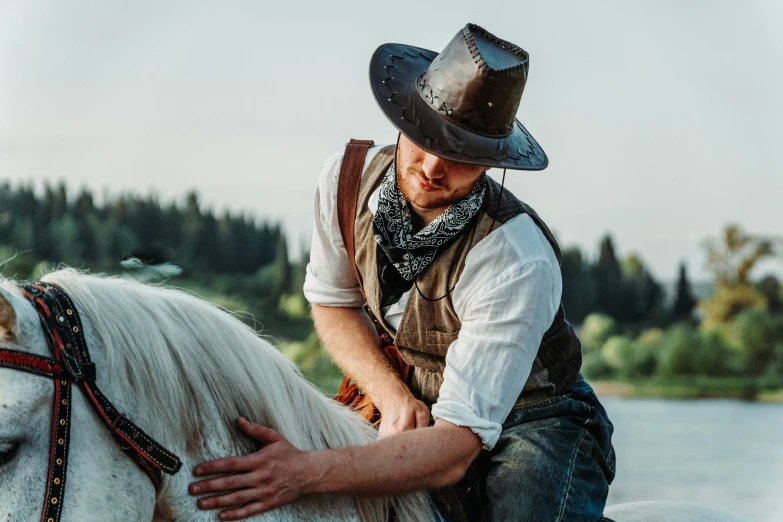 a man sitting on the back of a horse