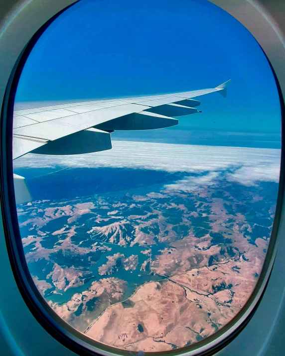 a po of the wing of an airplane from the window