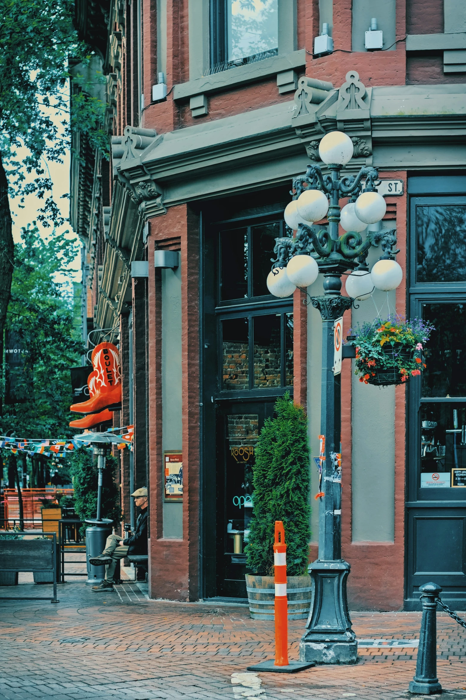 a large light pole sitting on the sidewalk