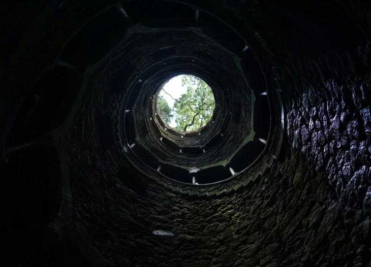 looking up into the center of a large dark tunnel