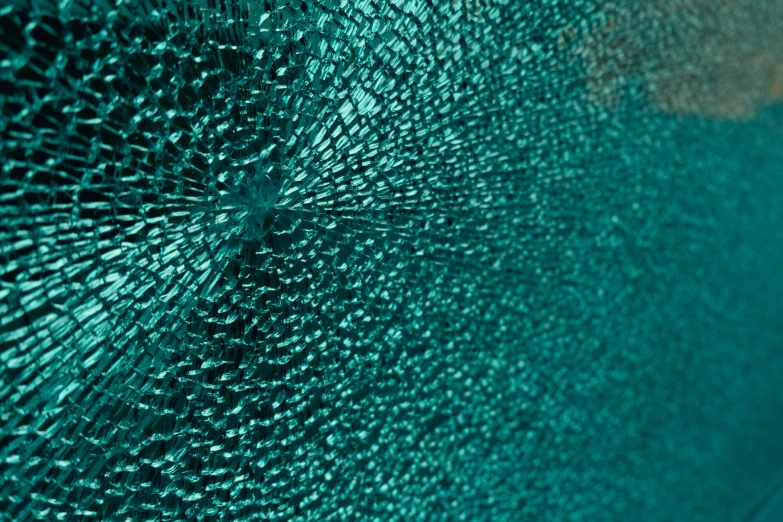 closeup of a mirror lens looking green with blue highlights