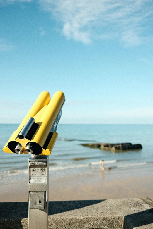 two yellow life jackets attached to a parking meter