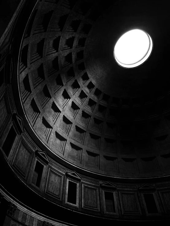 the light shines on a circular window in a building