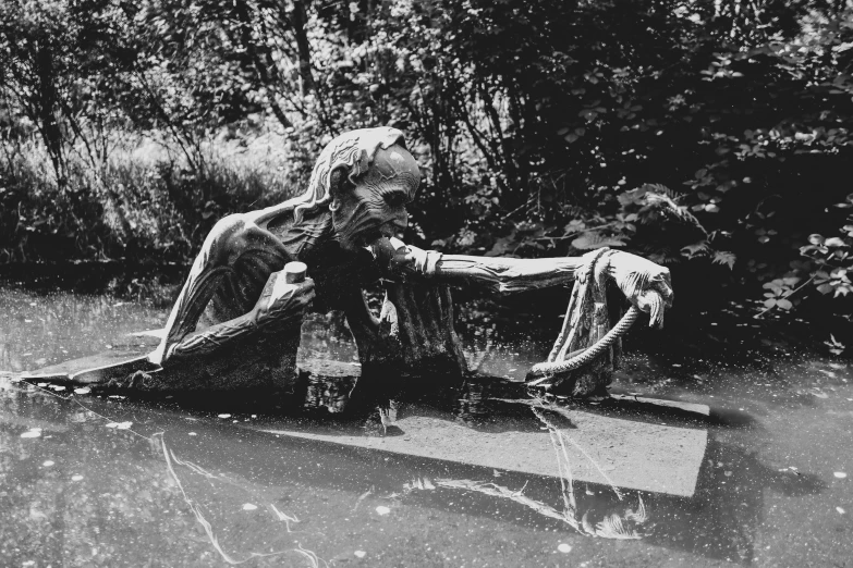 black and white po of a man laying in a boat in the water