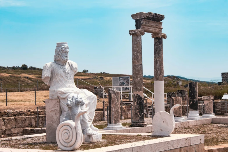 a statue of a person on a stone horse next to some columns