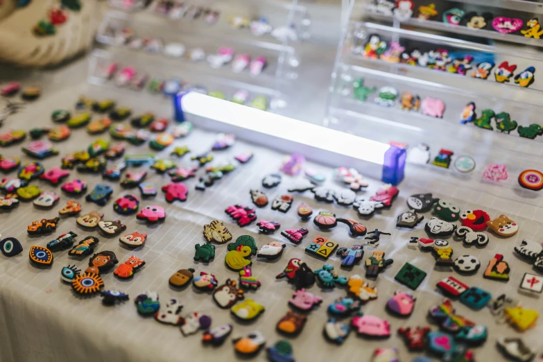 there are some plastic cars and brooches on the table