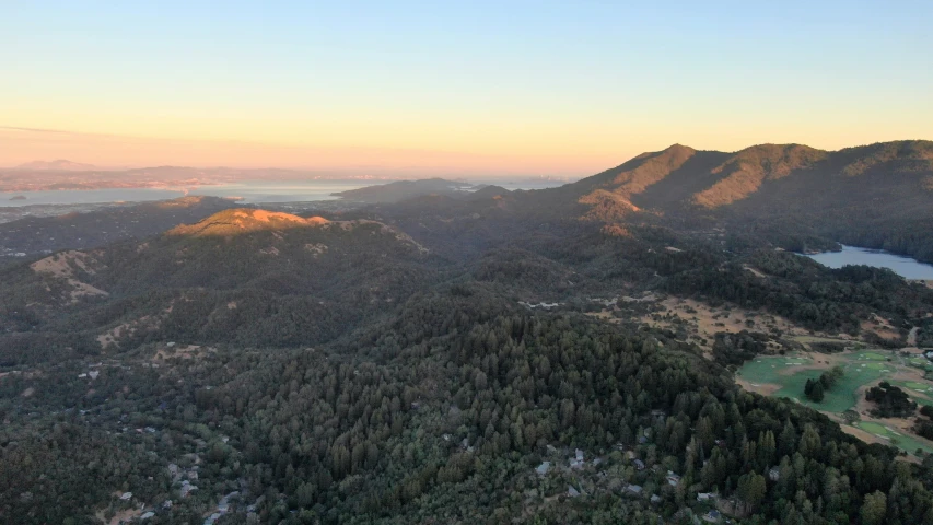 a bird - eye view of the wilderness with a small lake on the right