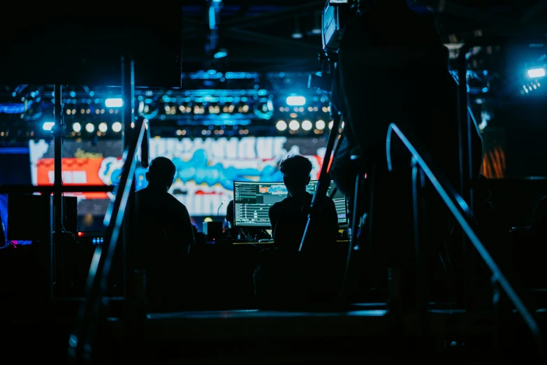 two people working on their laptops at night