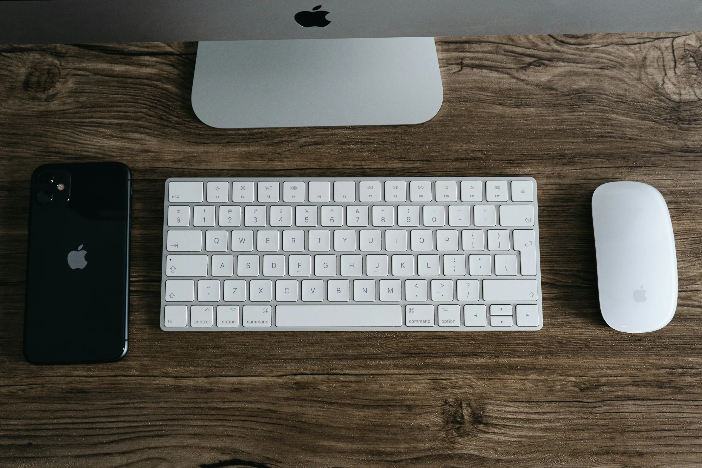 a computer keyboard and mouse sitting on a desk