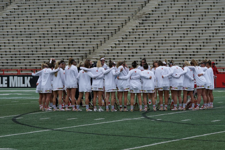 a group of female tennis players standing on a field