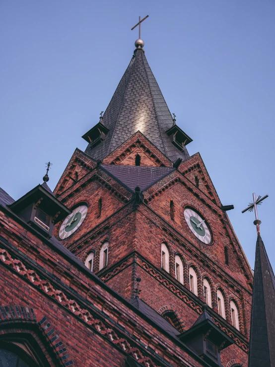 view looking up at a tall red brick church tower