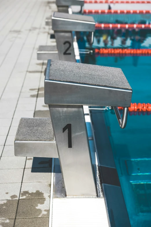 a close up s of a swimming pool bench and lanes