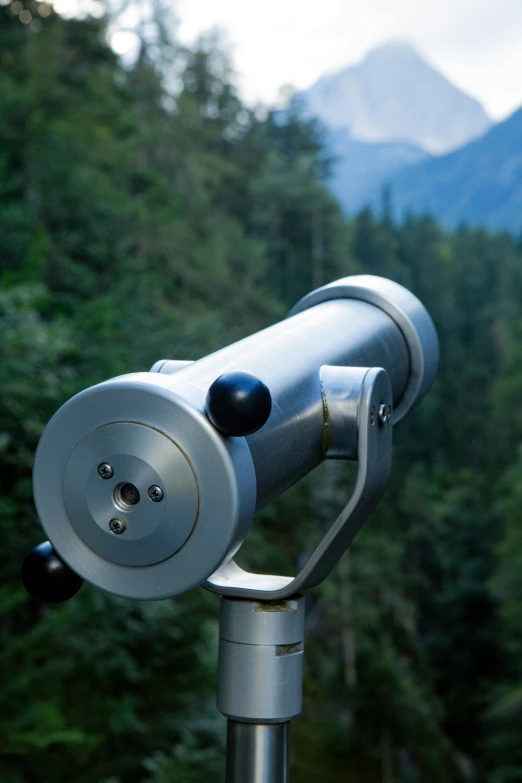 a view from the top of a telescope at a forest