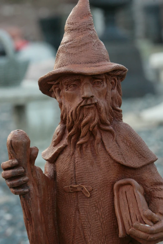 a statue in the shape of an old man wearing a gnome hat