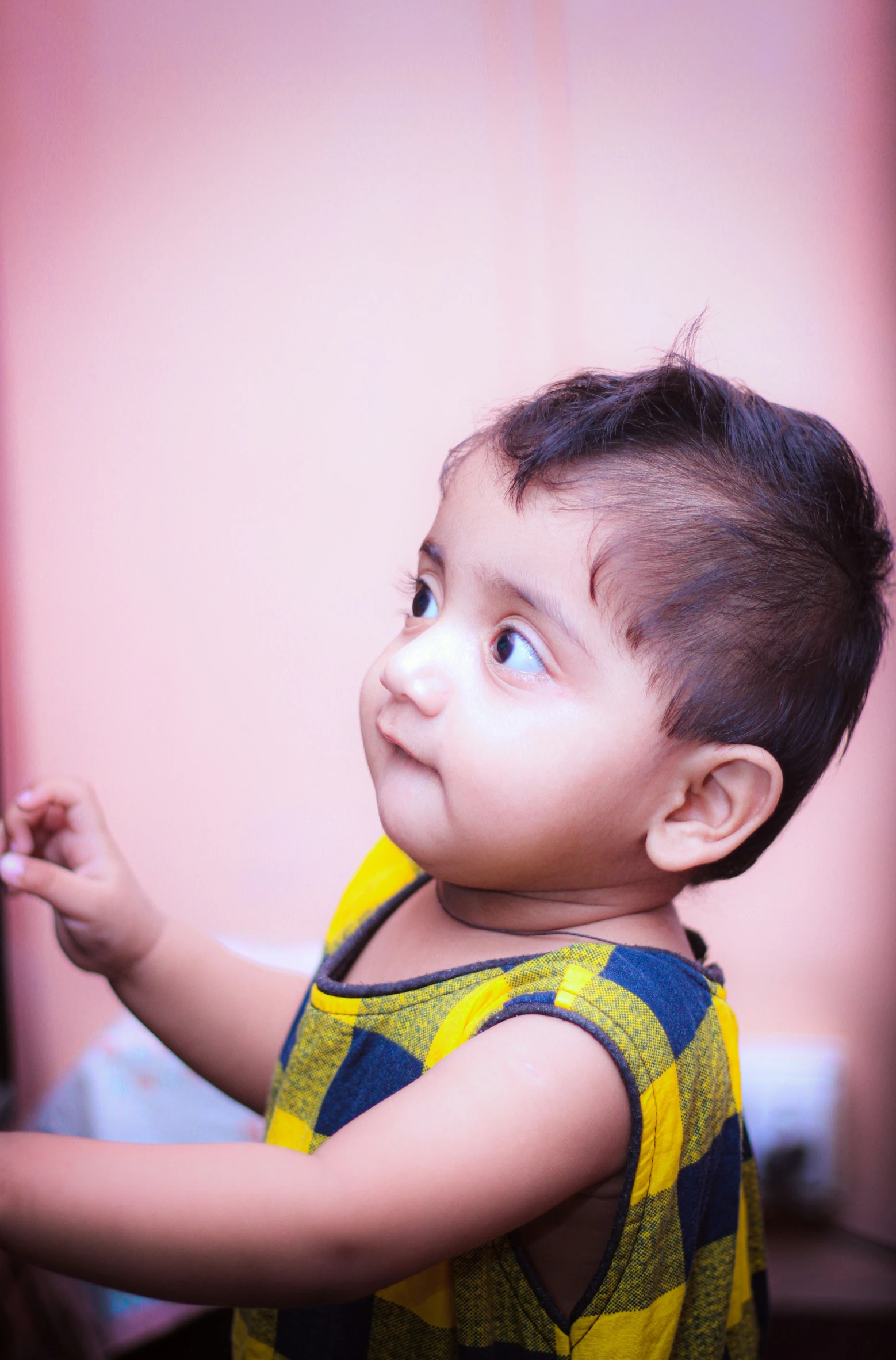 a small child standing on top of a wooden floor