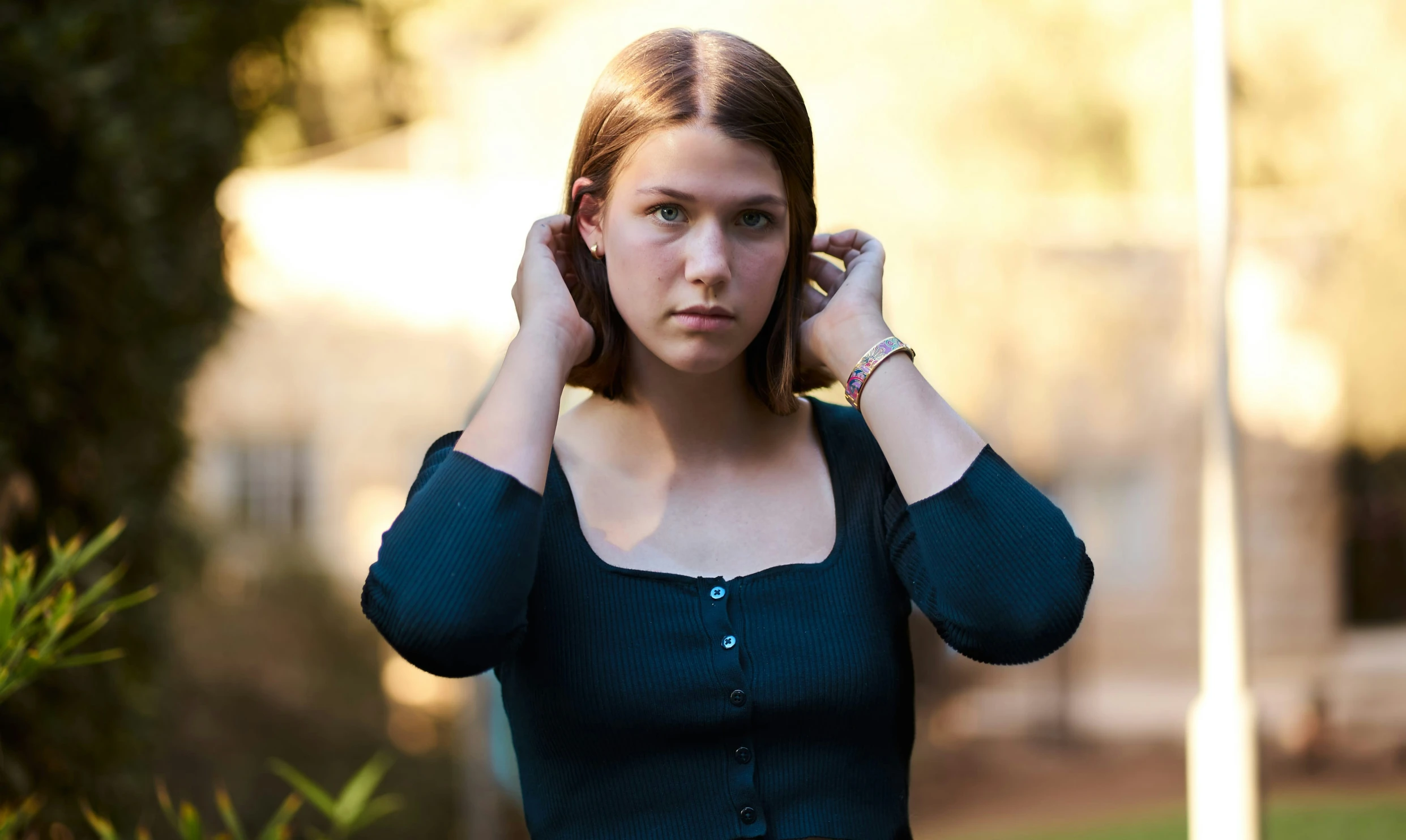 a woman with an ear ring is holding a cell phone