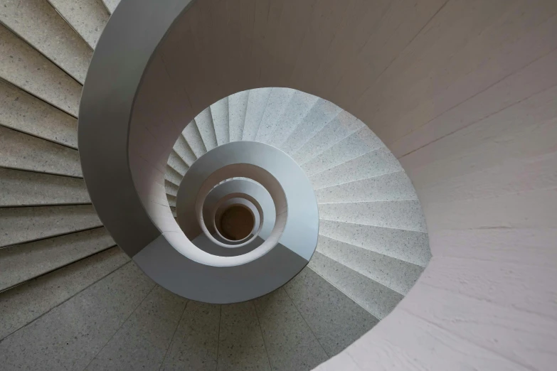 a large spiral staircase with white steps next to it