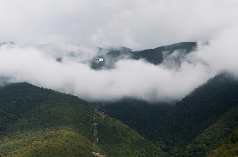 the clouds are covering the mountain tops