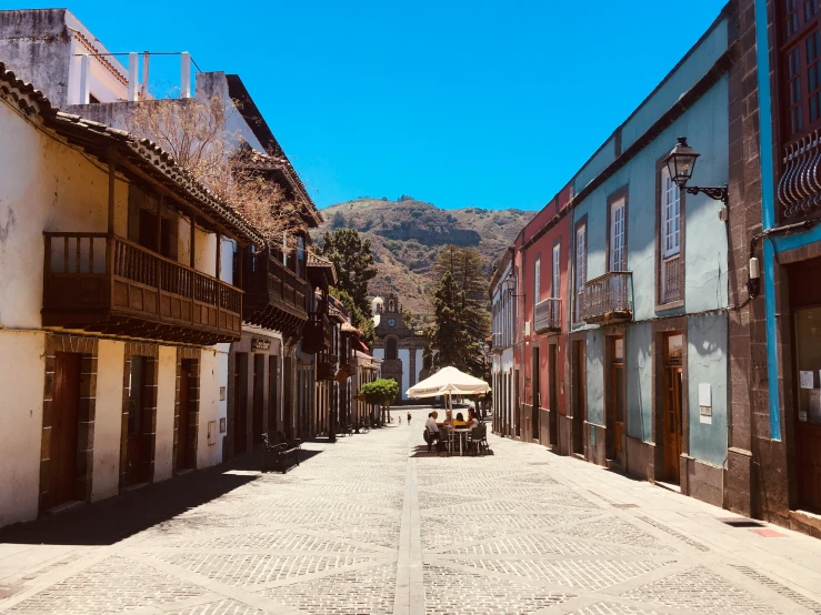 a narrow street lined with old building, and a restaurant