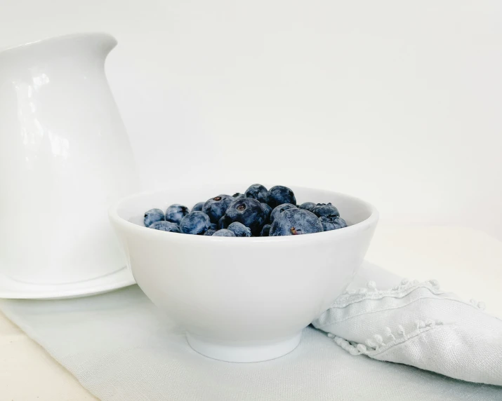 some berries and a jug on the table