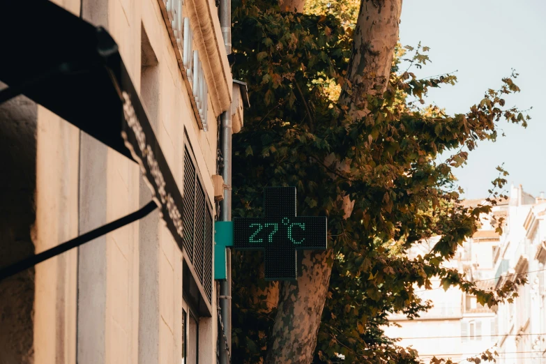 a city sign hanging from the side of a building