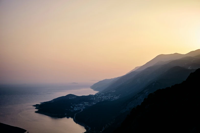 a view of the water below a mountain and sea