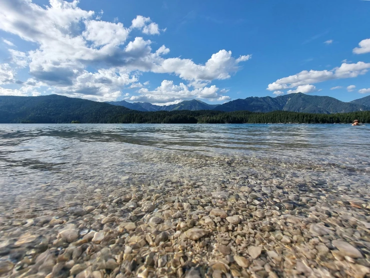 the view of mountains and water from the shore