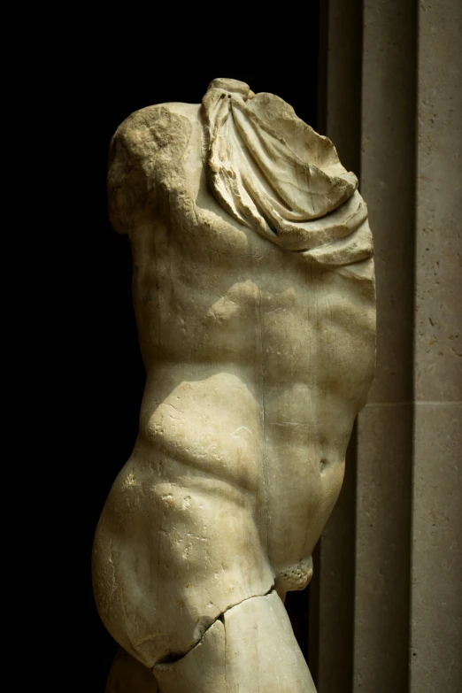 a statue of a female torso, viewed from the back