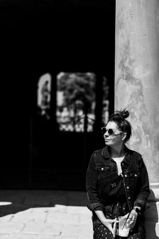 a woman with glasses on sitting on the steps