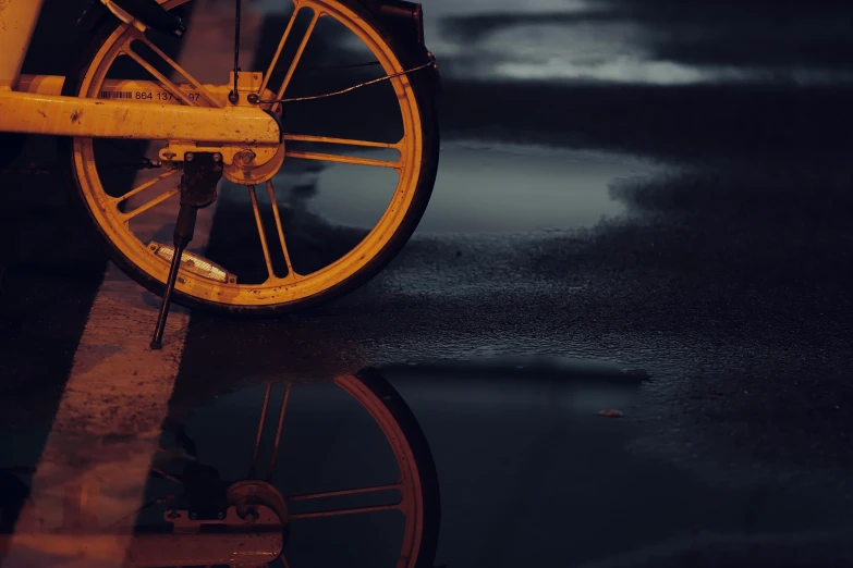 a yellow wheel that is sitting in the dark