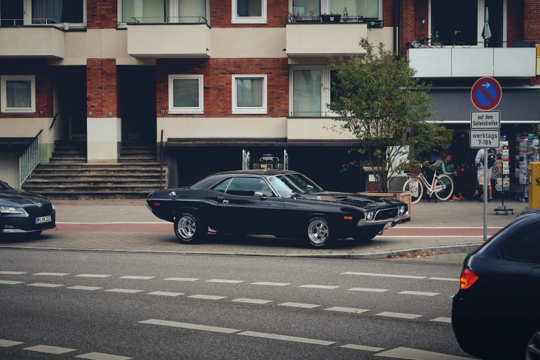 a black car in front of an apartment building