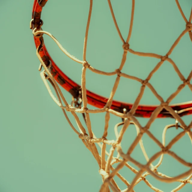 a close up view of a basketball net with a red object attached to it