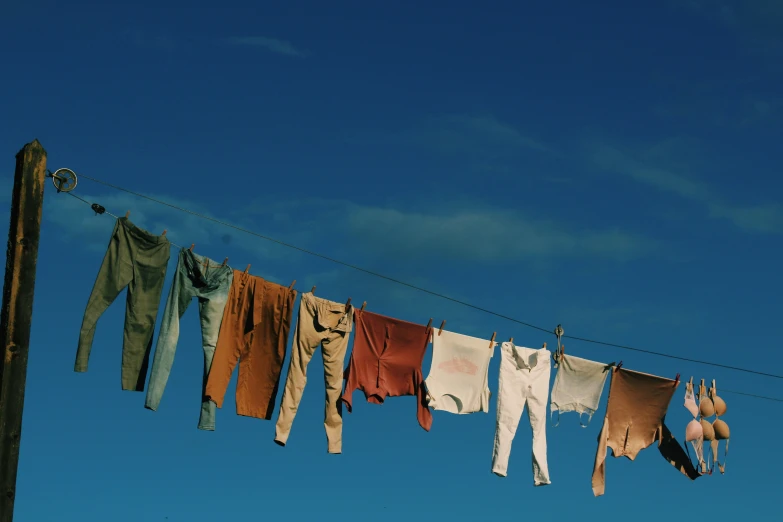 clothes drying on a clothesline with blue sky in the background