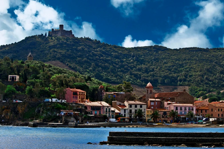 a city with several towers is next to a small body of water