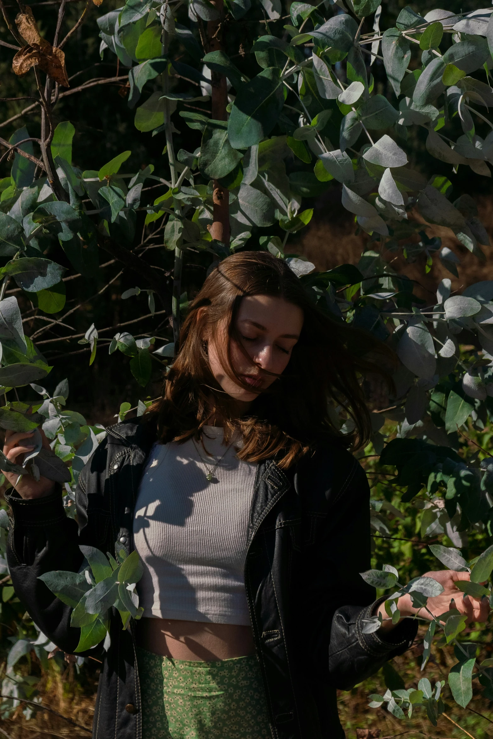 there is a woman standing in front of a tree