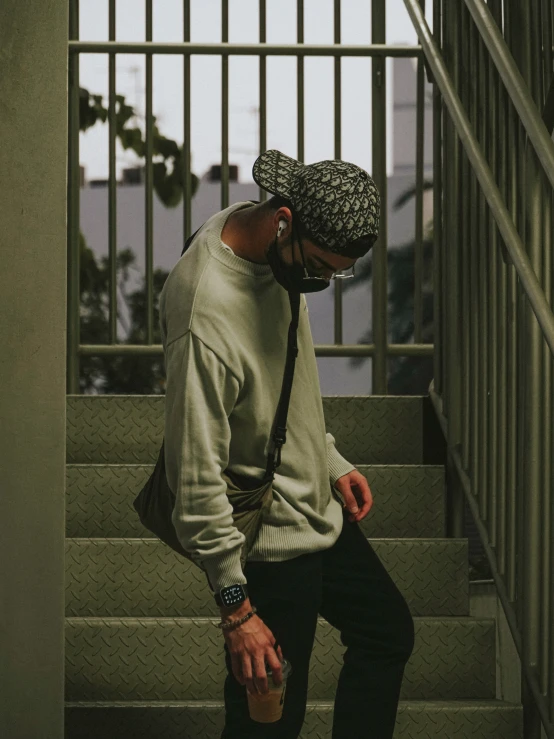 a man wearing a bandana walking up stairs