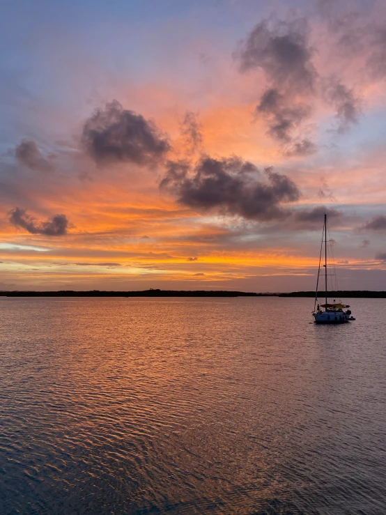 a small boat sailing on a body of water