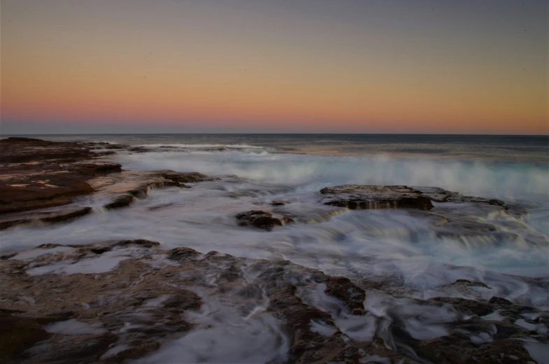 the beach is full of surf and rock formations