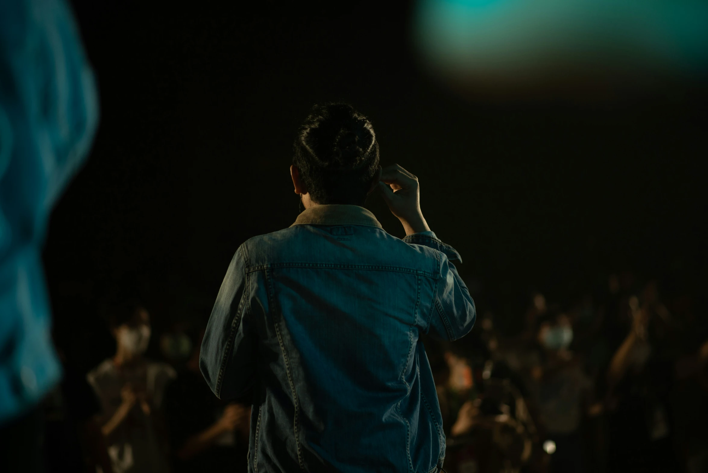 a man walking while holding a cell phone to his ear