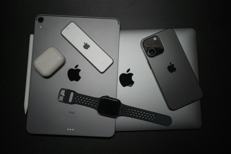 two ipad computers and a watch on the table