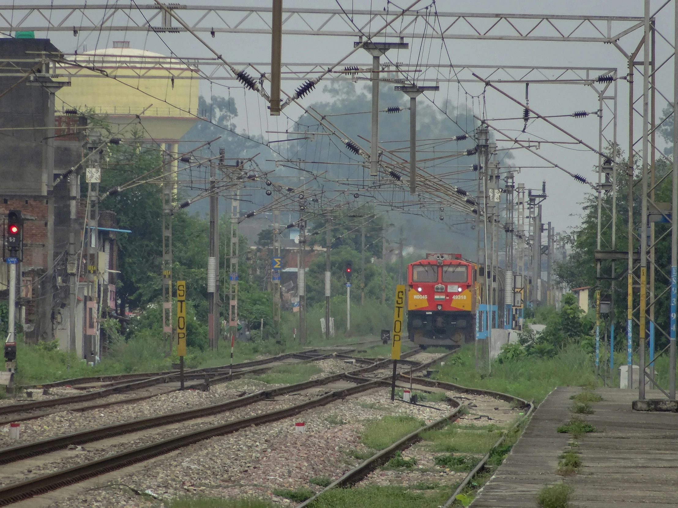 train running on tracks at train station near building