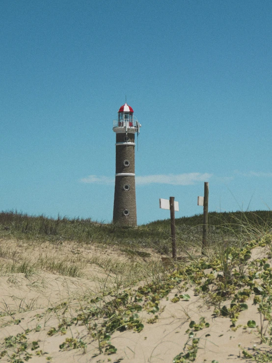a lighthouse that is on top of a hill