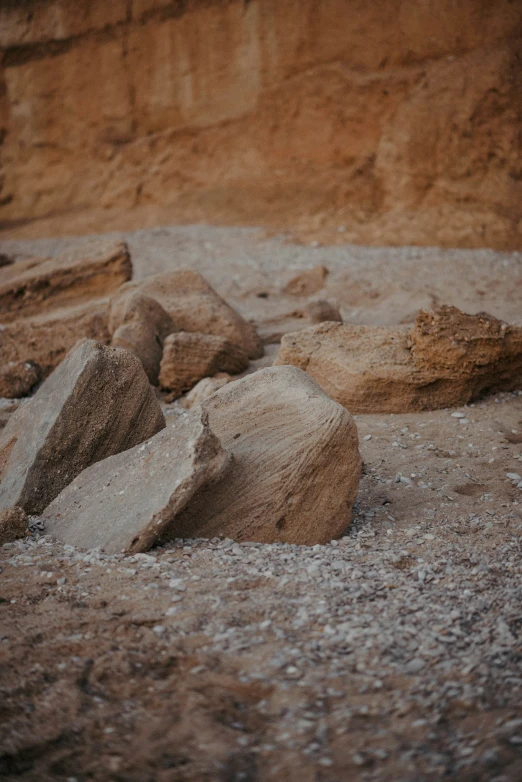 a close up of rocks on the ground near a cliff