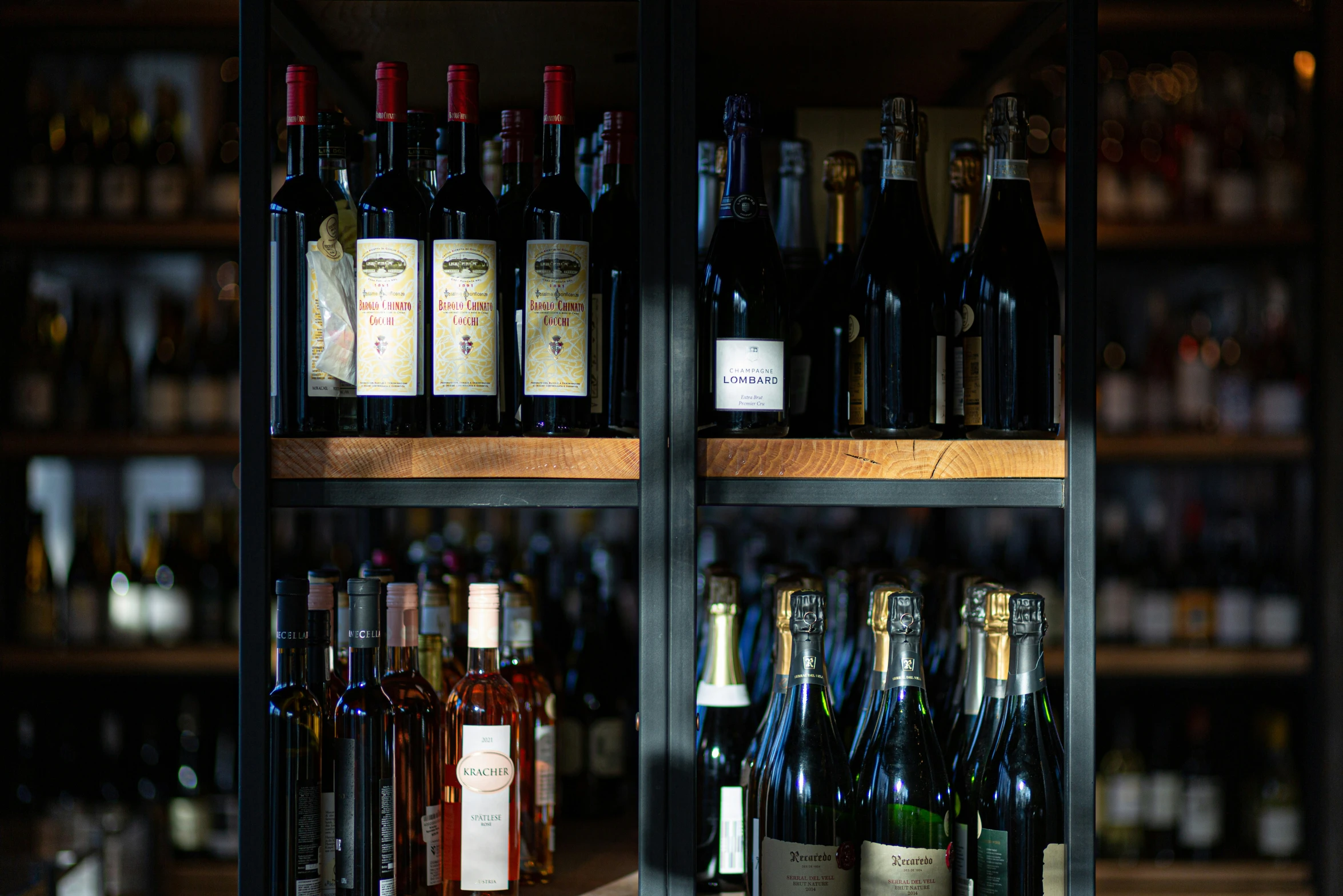 an assortment of different wines are on shelves