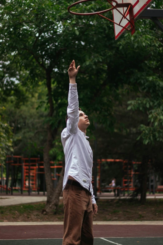 a man playing basketball is reaching for the hoop