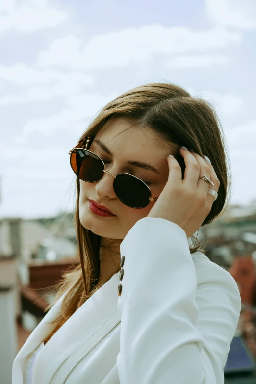 a woman in sunglasses is talking on the phone