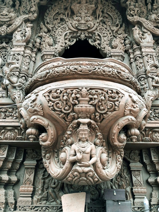 stone carving depicting a woman and bird and an arch at the entrance to an ancient temple, pattukal temple, orissan