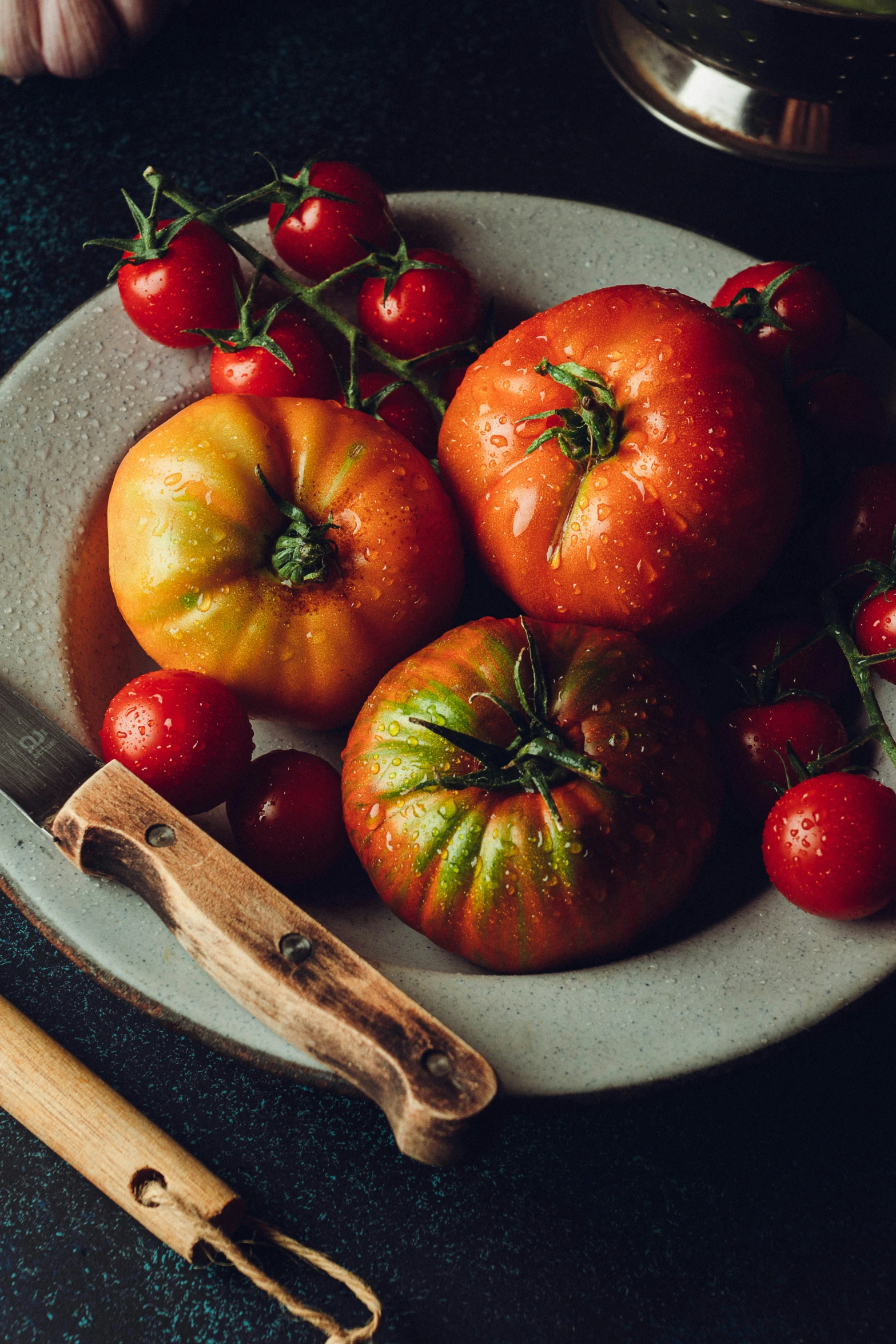 some tomatoes are lying on a white plate