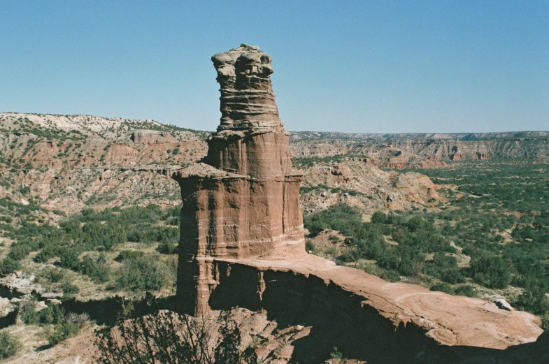 a large old tower in the middle of a field